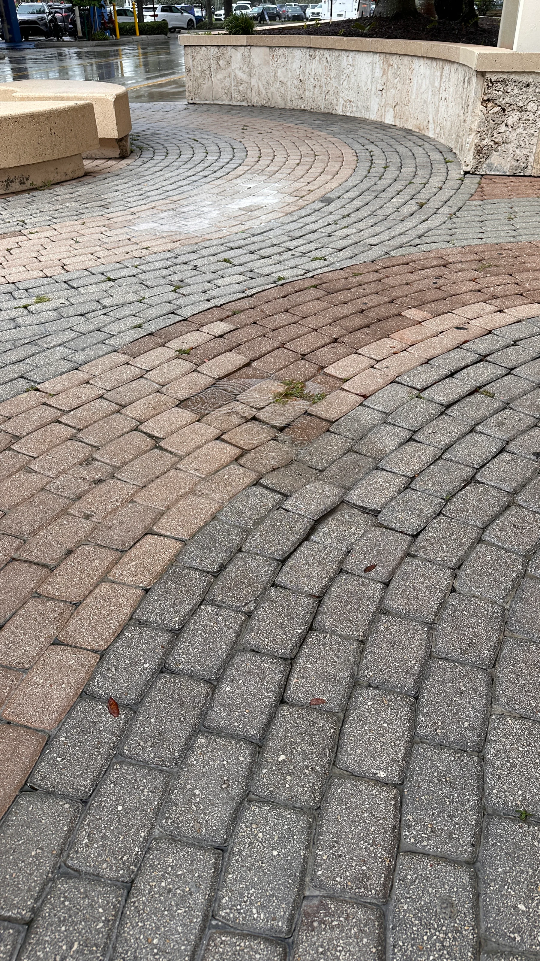 Damaged pavers along a curved outdoor surface in Palm Beach County