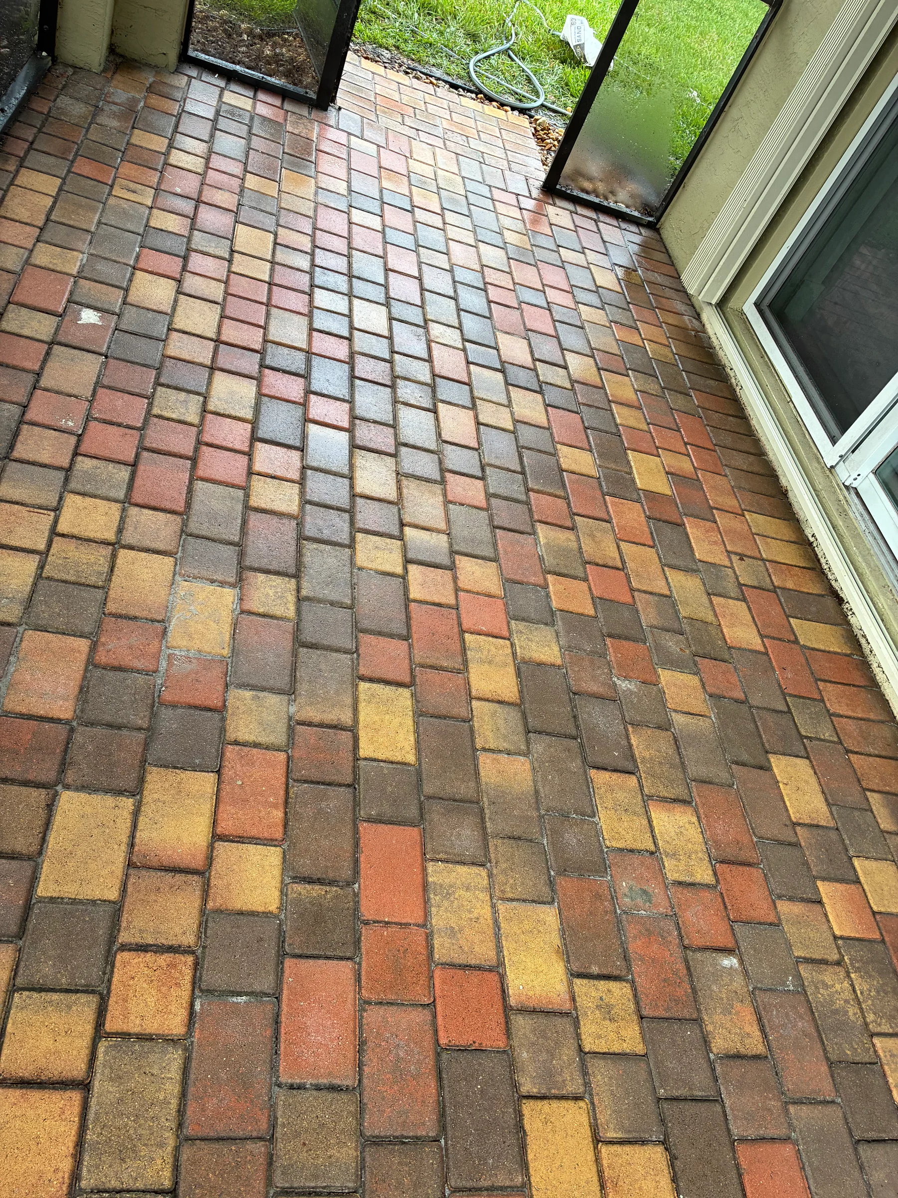 Detailed view of reset brick pavers after a Delray Beach drainage-related patio repair
