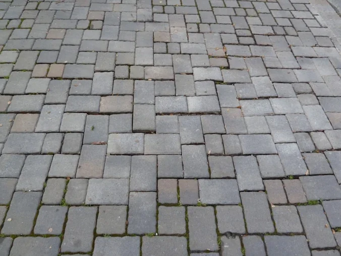 Gray driveway pavers reset into an even finished surface