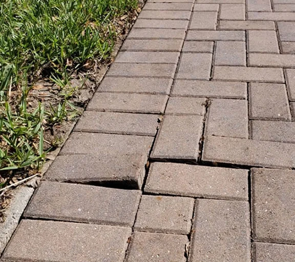Failed paver edge and base condition before repair