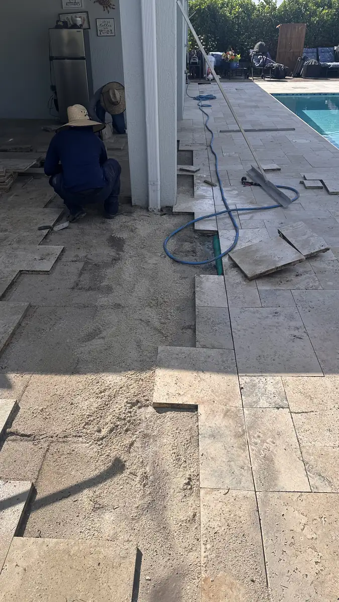 Hidden drainage line exposed during a Delray Beach paver repair