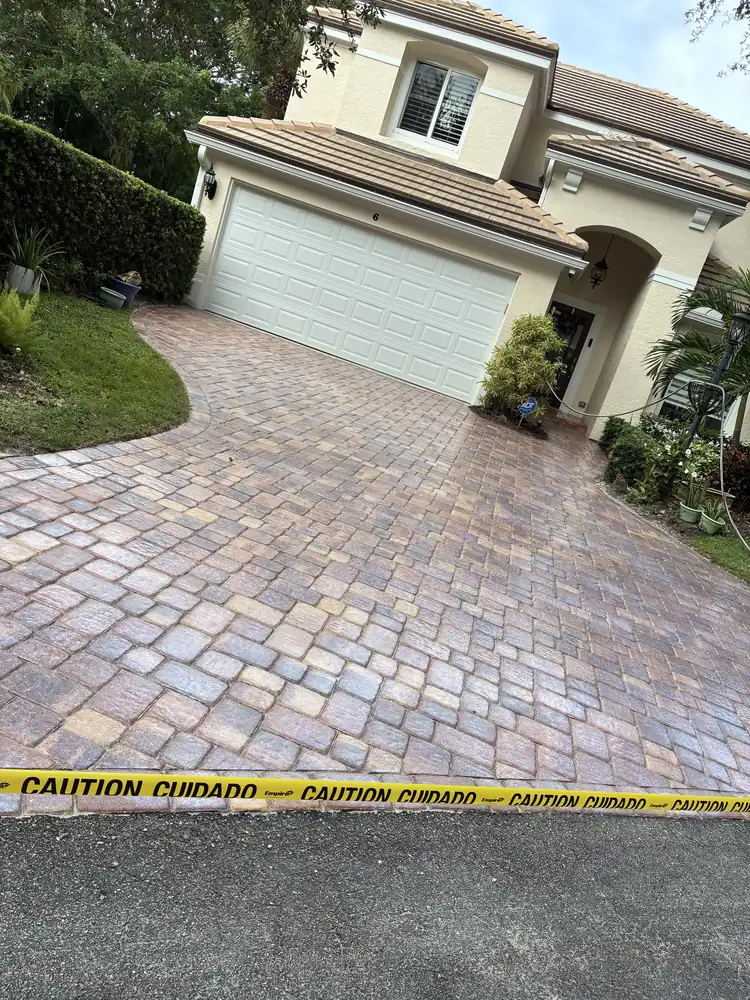 Completed Palm Beach County driveway after tree-root paver repair and resetting